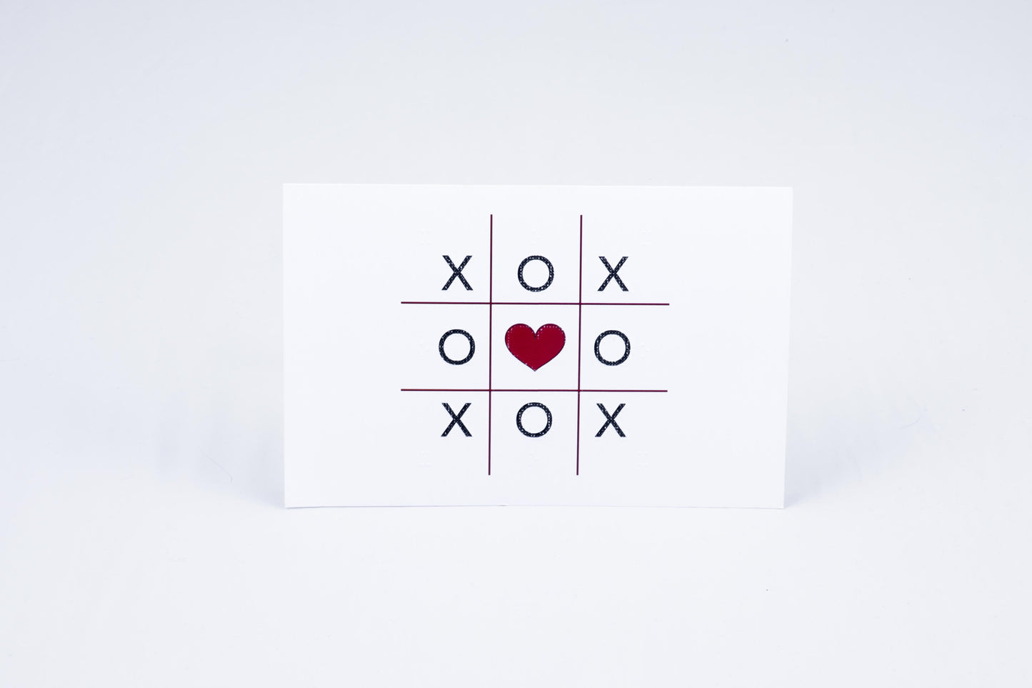 Tic-tac-toe with a heart in the middle
