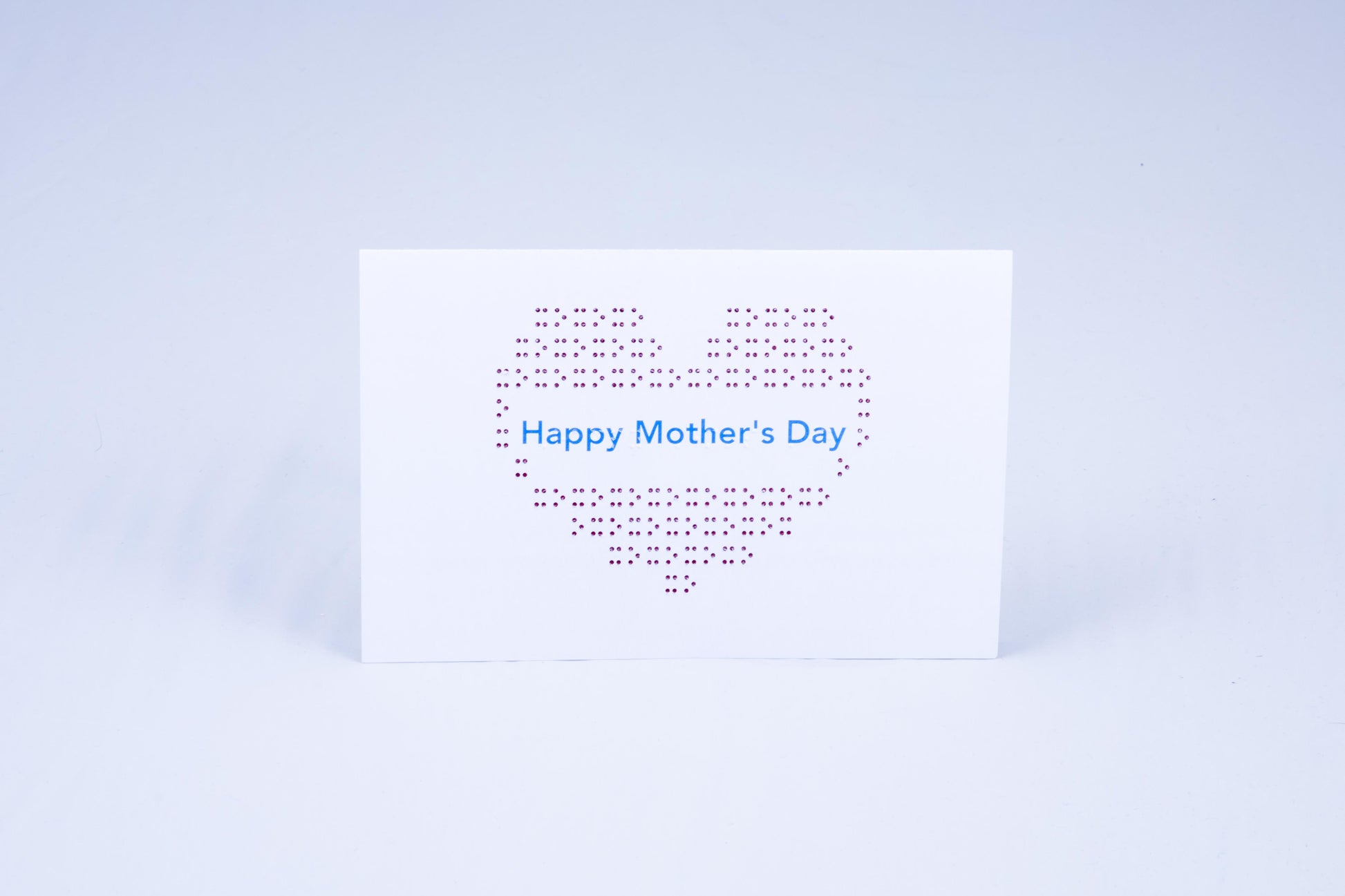 A big heart made of tactile braille with greeting in the middle