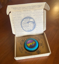 Load image into Gallery viewer, Bop It Button in classic &#39;90s colors (teal, purple, and black) in its box