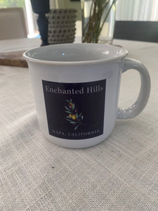 White ceramic mug with Enchanted Hills purple logo