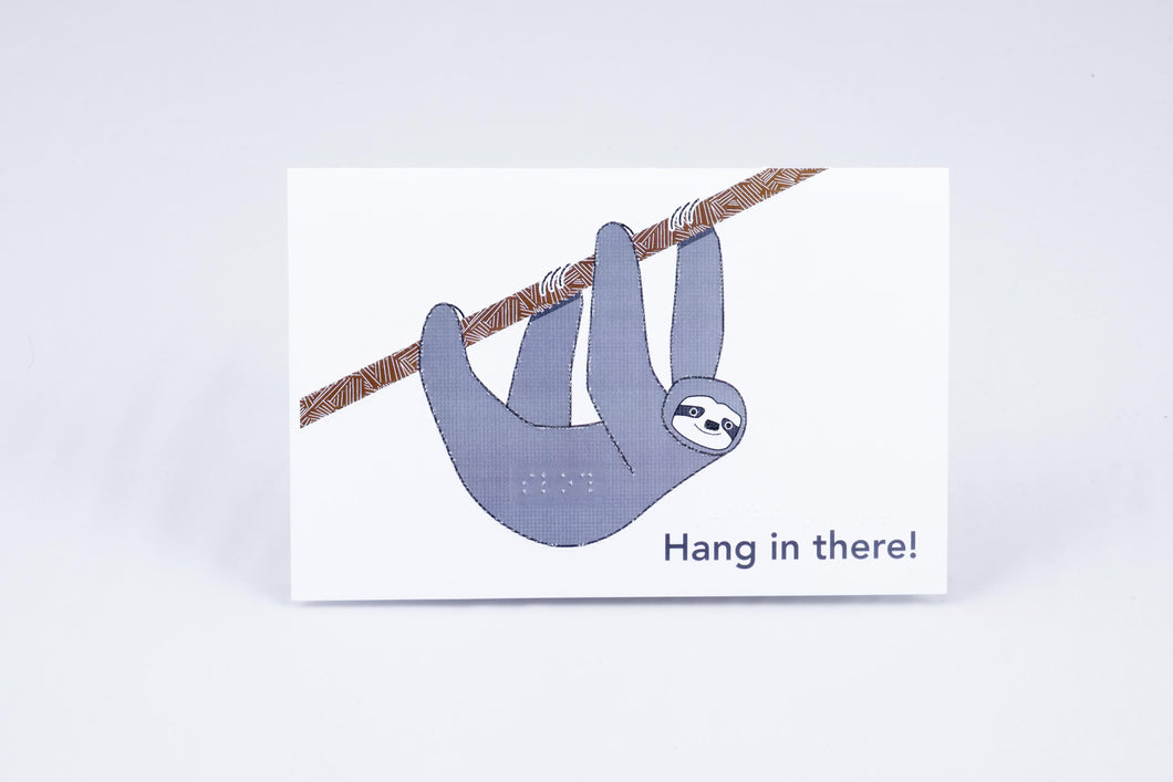 A sloth hanging off a branch w/ greeting
