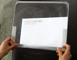 Full Page Magnifier, 14" x 12", 3.5X, displaying the LightHouse letterhead magnified approximately 3.5x