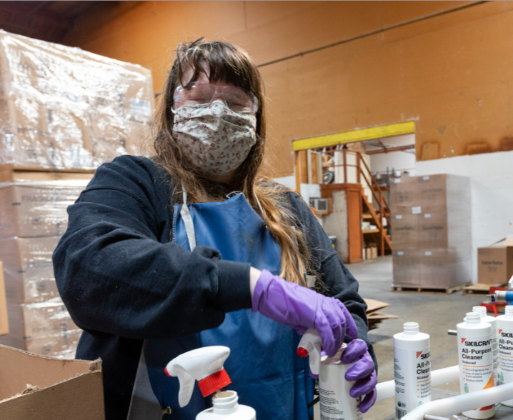 LightHouse employee packing up Skilcraft cleaning bottles